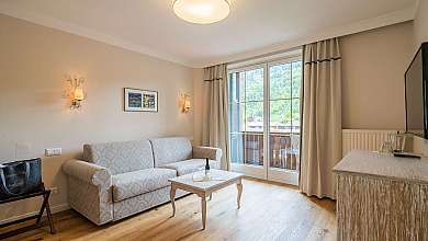 Bright living room with sofa, coffee table and balcony windows